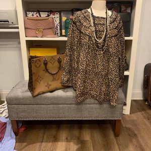 - The animal print with smocking around neck